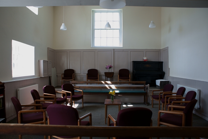 Image of main meeting room looking towards raised dais at front of room.
