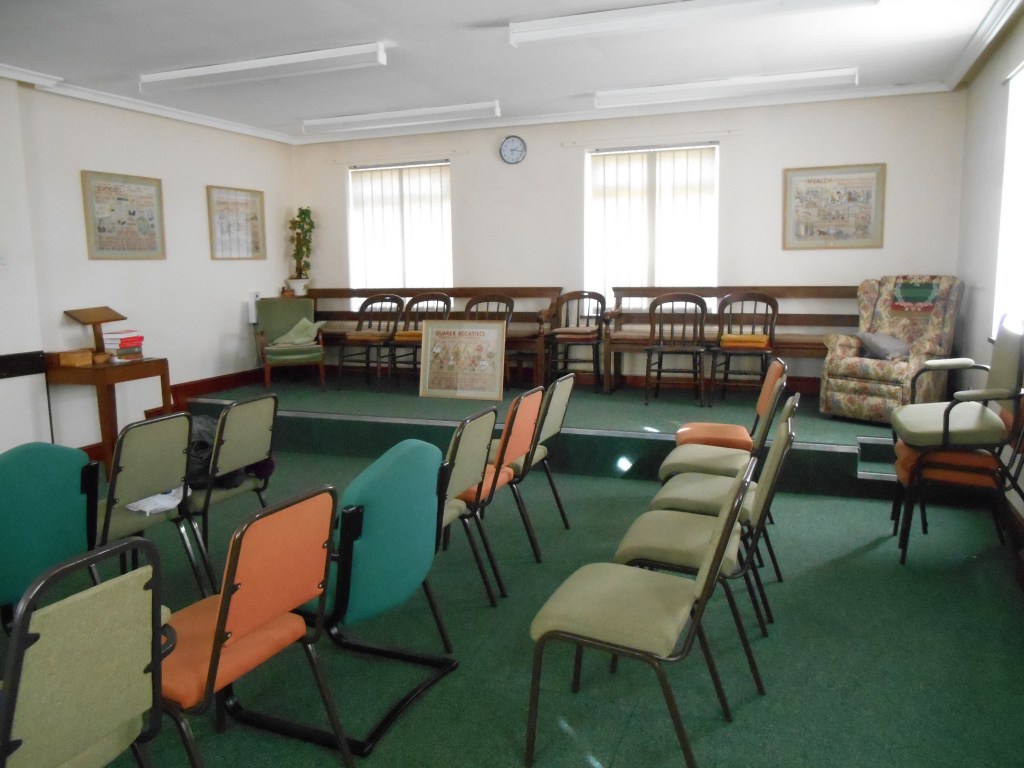 Image shows the main meeting room looking towards the front of the room showing raised dais.